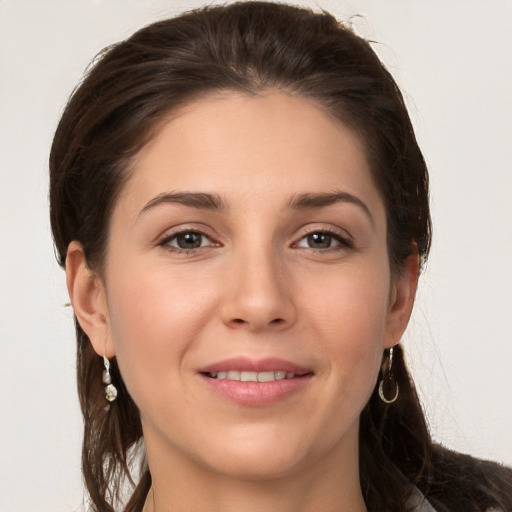 Joyful white young-adult female with long  brown hair and grey eyes