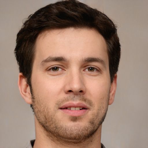 Joyful white young-adult male with short  brown hair and brown eyes