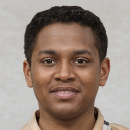 Joyful latino young-adult male with short  brown hair and brown eyes