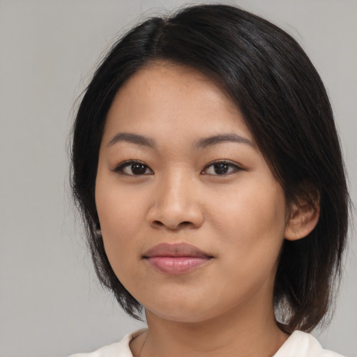 Joyful latino young-adult female with medium  black hair and brown eyes