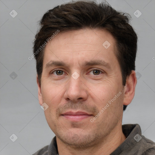 Joyful white adult male with short  brown hair and grey eyes