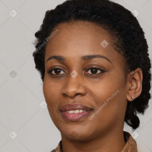 Joyful black young-adult female with short  black hair and brown eyes