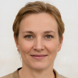 Joyful white adult female with medium  brown hair and grey eyes