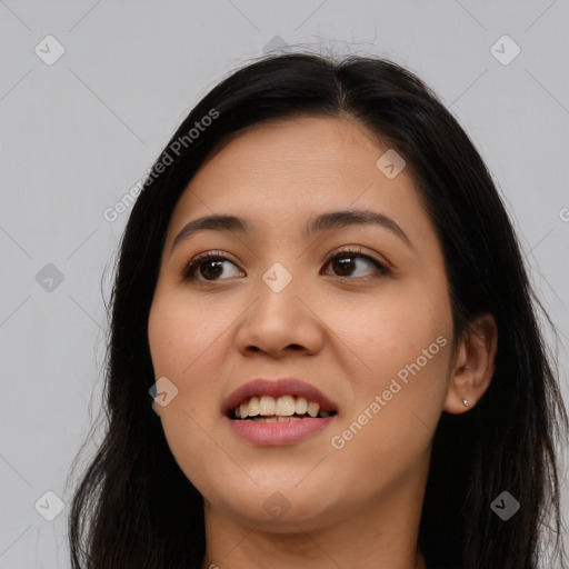 Joyful latino young-adult female with long  black hair and brown eyes