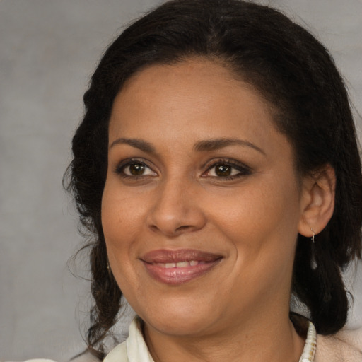 Joyful black adult female with medium  brown hair and brown eyes