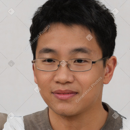 Joyful asian young-adult male with short  brown hair and brown eyes