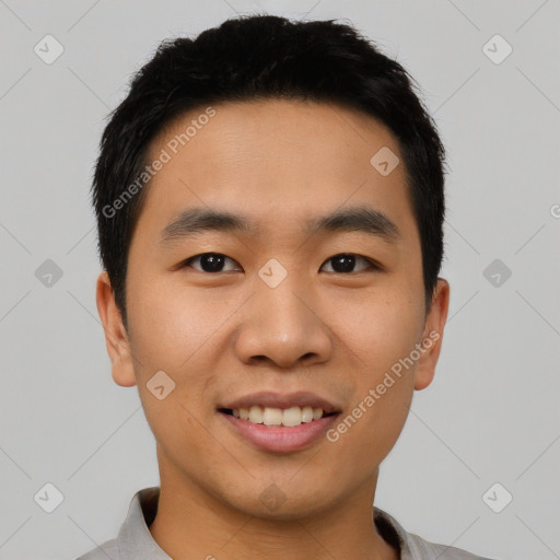 Joyful asian young-adult male with short  black hair and brown eyes