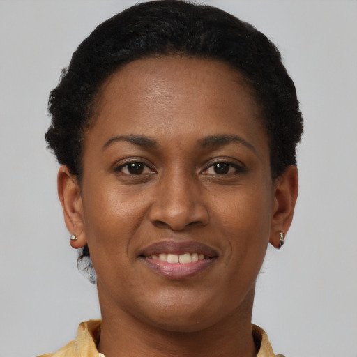 Joyful black young-adult female with short  brown hair and brown eyes