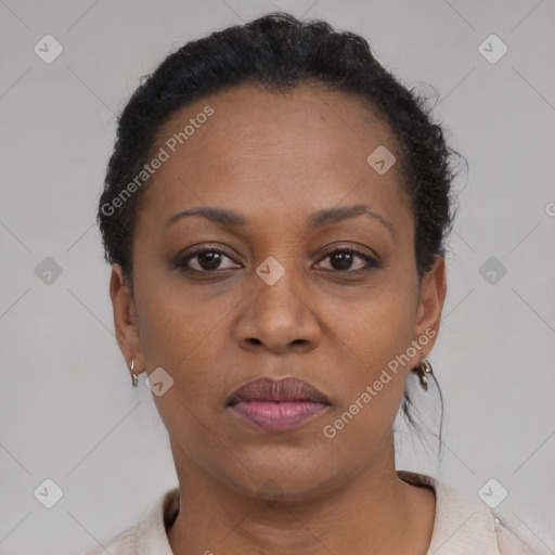 Joyful black adult female with short  brown hair and brown eyes