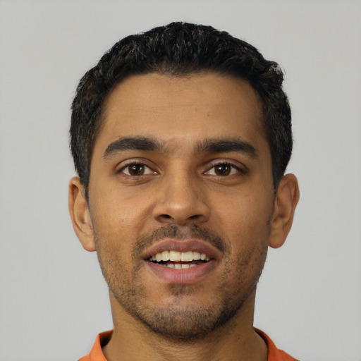 Joyful latino young-adult male with short  black hair and brown eyes