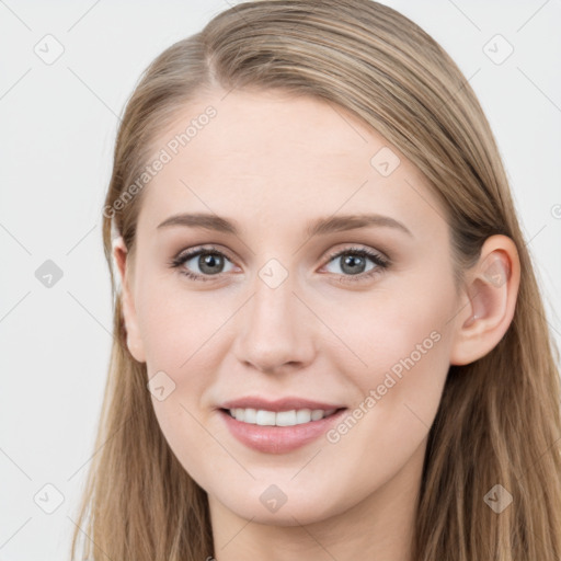 Joyful white young-adult female with long  brown hair and blue eyes