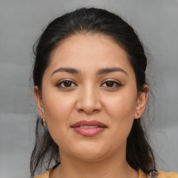 Joyful latino young-adult female with medium  brown hair and brown eyes