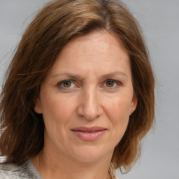 Joyful white adult female with medium  brown hair and blue eyes