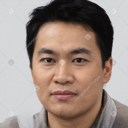 Joyful asian young-adult male with short  black hair and brown eyes