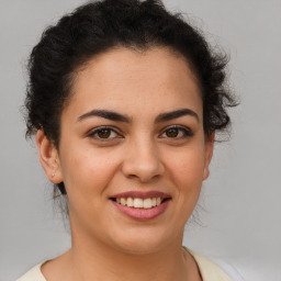 Joyful latino young-adult female with short  brown hair and brown eyes