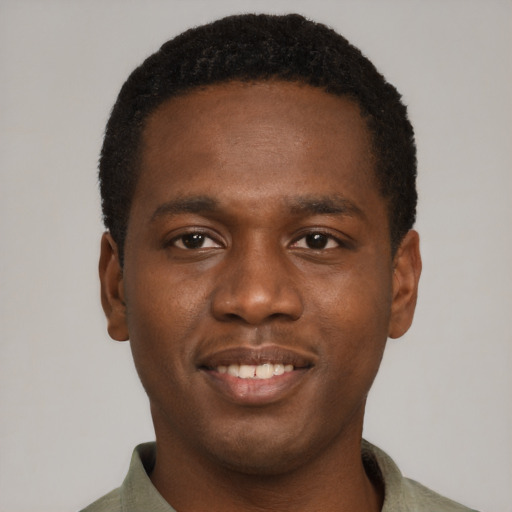 Joyful black young-adult male with short  brown hair and brown eyes