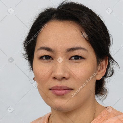 Joyful asian adult female with medium  brown hair and brown eyes