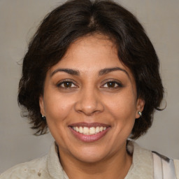 Joyful white adult female with medium  brown hair and brown eyes