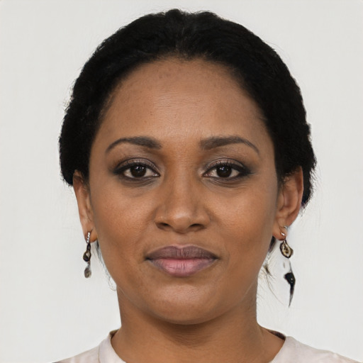 Joyful black adult female with short  black hair and brown eyes