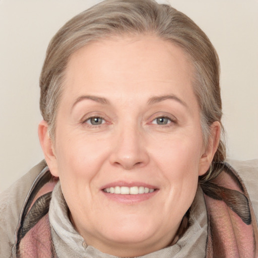 Joyful white adult female with medium  brown hair and blue eyes