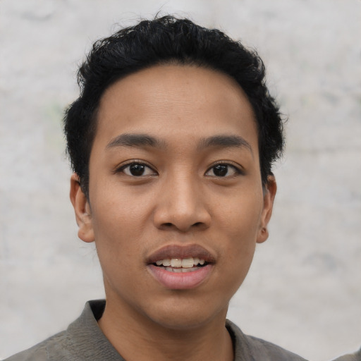 Joyful asian young-adult male with short  black hair and brown eyes