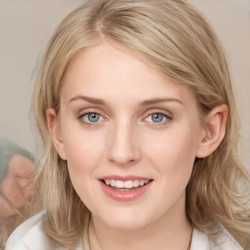 Joyful white young-adult female with medium  brown hair and blue eyes