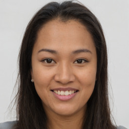 Joyful asian young-adult female with long  brown hair and brown eyes