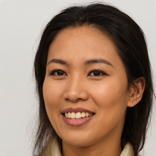 Joyful asian young-adult female with long  brown hair and brown eyes