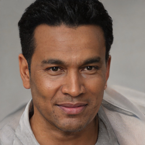 Joyful latino adult male with short  black hair and brown eyes