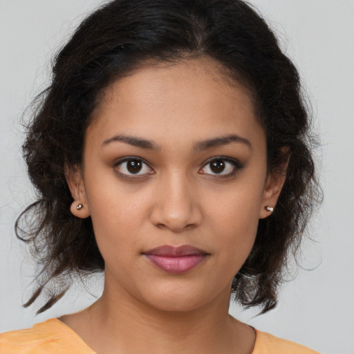 Joyful latino young-adult female with medium  brown hair and brown eyes