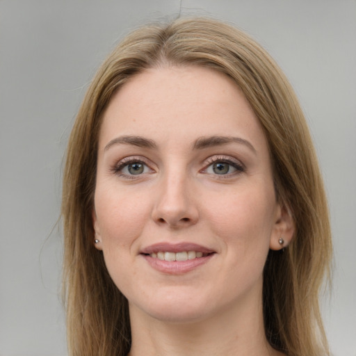 Joyful white young-adult female with long  brown hair and green eyes