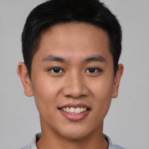 Joyful asian young-adult male with short  black hair and brown eyes