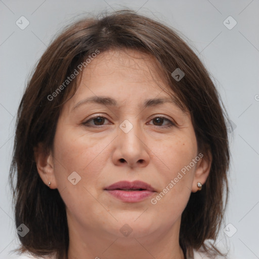 Joyful white adult female with medium  brown hair and brown eyes