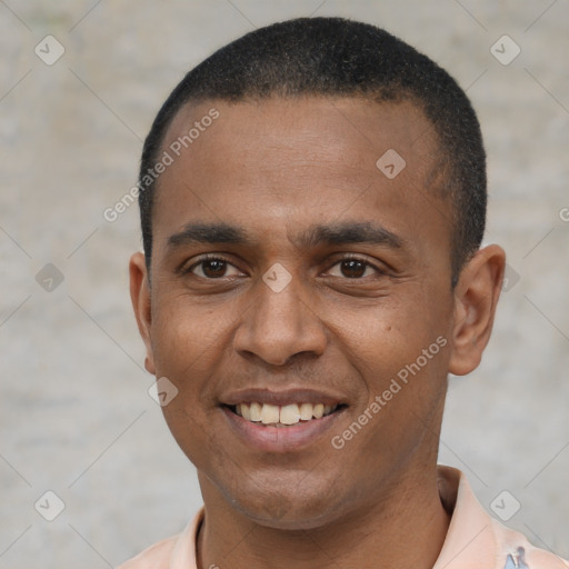 Joyful black young-adult male with short  black hair and brown eyes