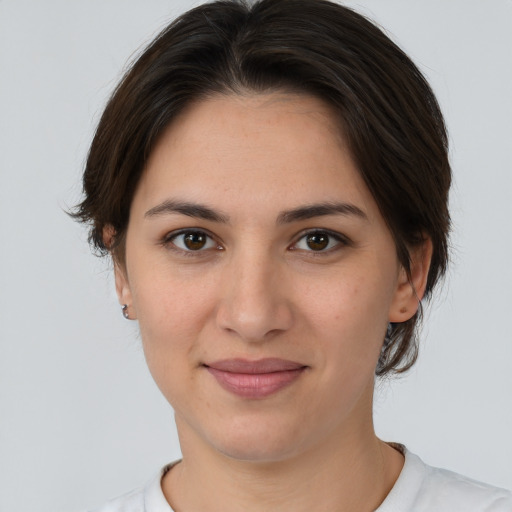 Joyful white young-adult female with short  brown hair and brown eyes