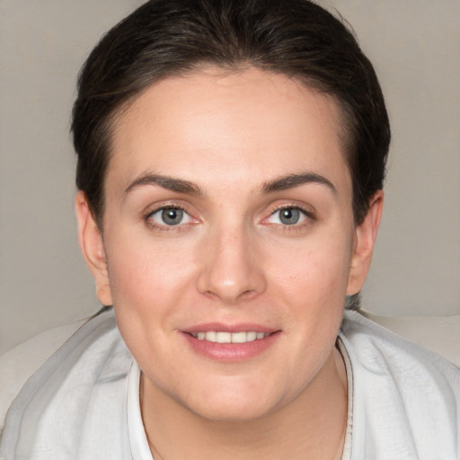 Joyful white young-adult female with short  brown hair and brown eyes