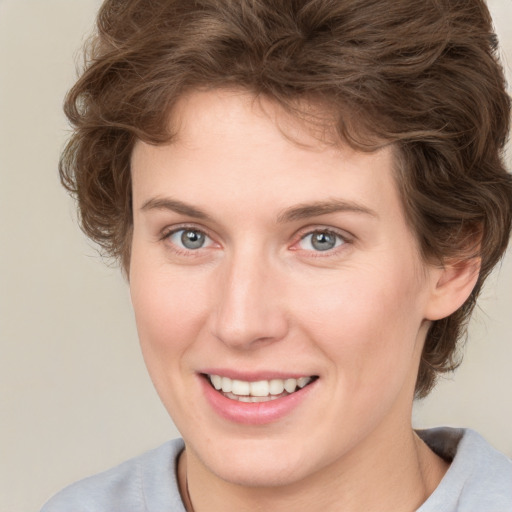 Joyful white young-adult female with medium  brown hair and blue eyes