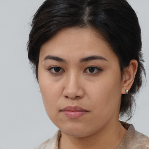 Joyful asian young-adult female with medium  brown hair and brown eyes