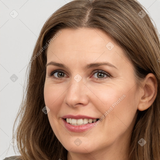 Joyful white adult female with long  brown hair and brown eyes