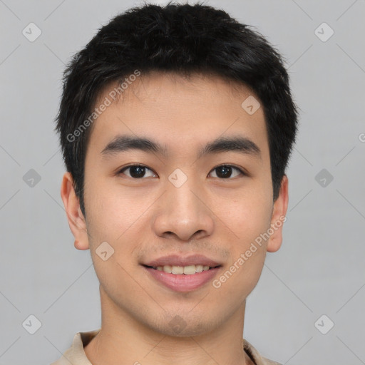 Joyful asian young-adult male with short  brown hair and brown eyes