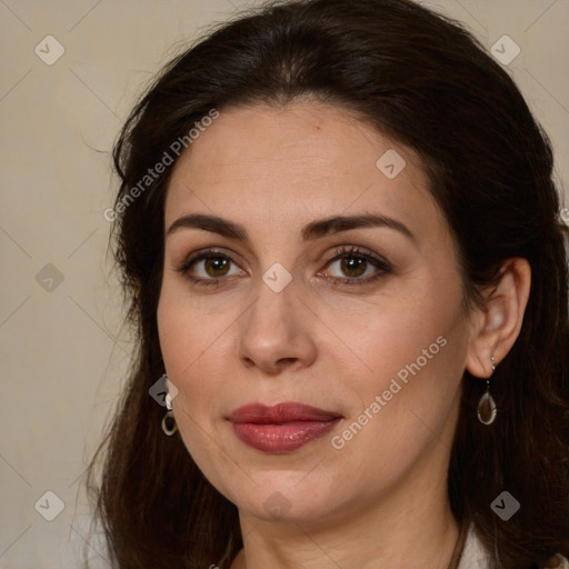 Joyful white adult female with long  brown hair and brown eyes