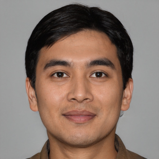 Joyful asian young-adult male with short  black hair and brown eyes