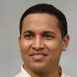 Joyful latino adult male with short  brown hair and brown eyes