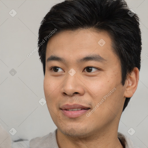 Joyful asian young-adult male with short  black hair and brown eyes