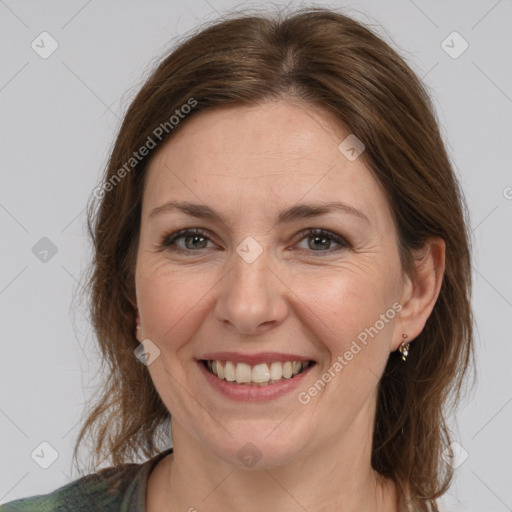 Joyful white adult female with medium  brown hair and grey eyes