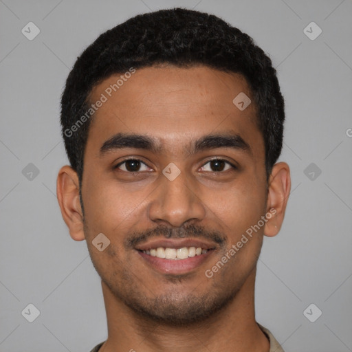 Joyful latino young-adult male with short  black hair and brown eyes