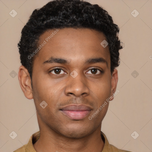 Joyful black young-adult male with short  brown hair and brown eyes