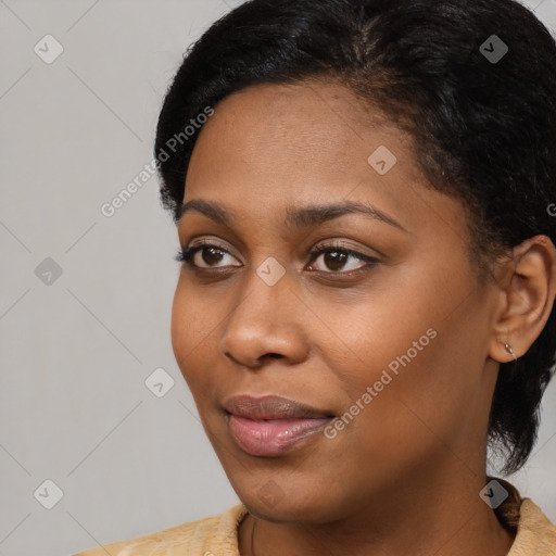 Joyful black young-adult female with short  black hair and brown eyes