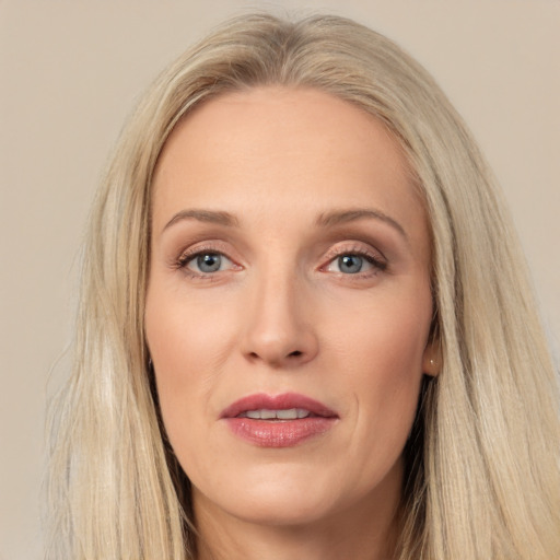 Joyful white adult female with long  brown hair and brown eyes