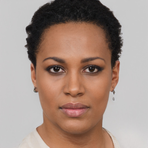 Joyful black young-adult female with short  black hair and brown eyes